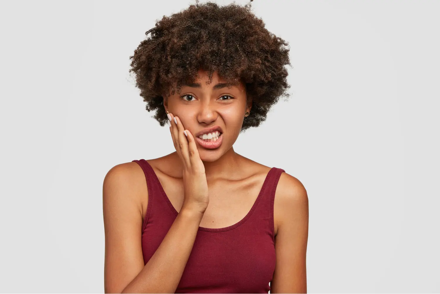 Woman Grimacing From Tooth Pain