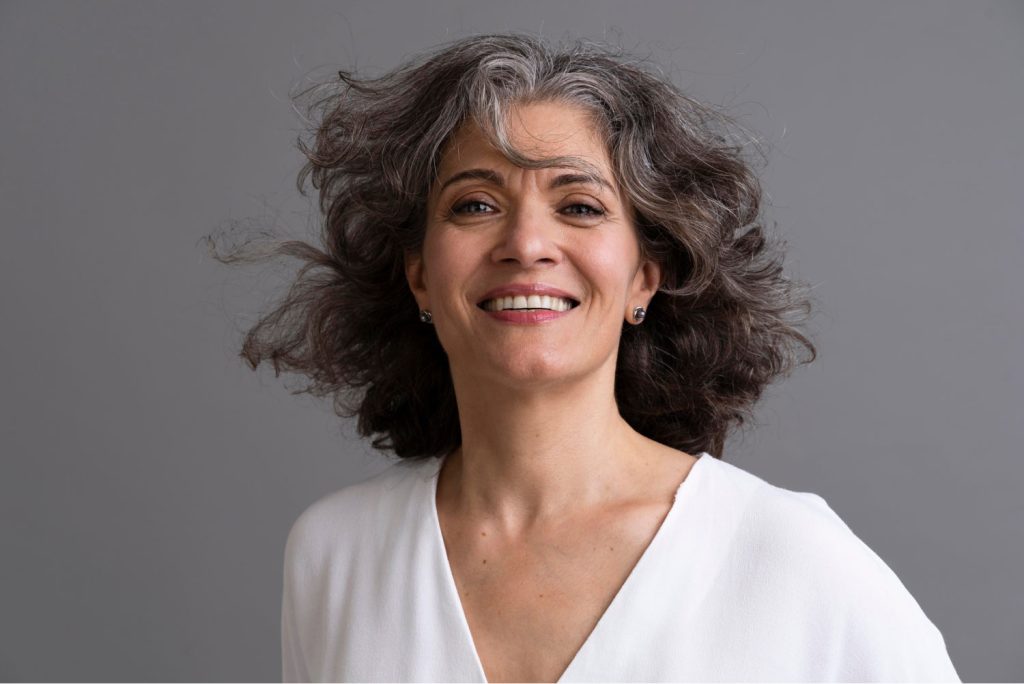 Aged Woman Smiling Post Dental Crown Treatment In Toluca Lake, CA